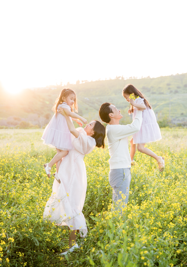 happy family having fun in a flower field